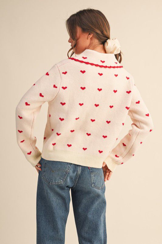 Suéter corazones rosa